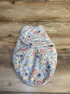 Floral fleece baby swaddle blanket with pink and blue flowers on wooden background