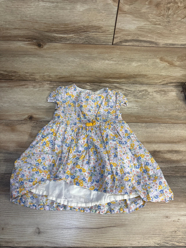 Floral baby dress with yellow, blue, and pink flowers, short sleeves, and bow detail