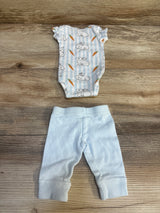 Baby bunny and carrot print onesie with light blue pants, newborn outfit on wood floor