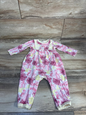 Baby girl floral print romper with long sleeves and snap closures on wooden floor
