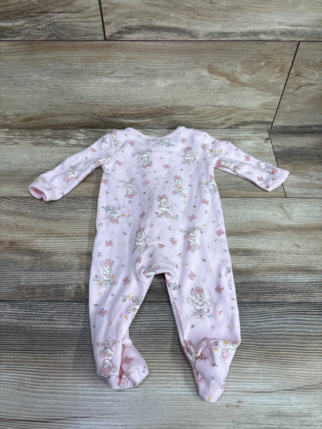 Front view of pink Minnie Mouse footed sleeper size 0 to 3 months with long sleeves and character print on wood look floor