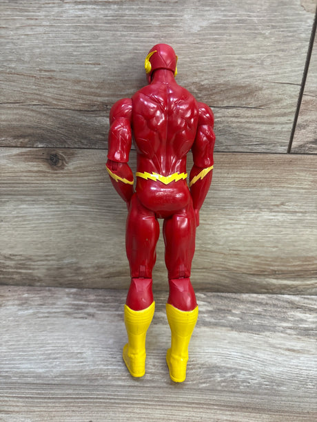 Rear view of DC Comics 12-inch The Flash action figure showcasing red and yellow costume details against a wood-grain background
