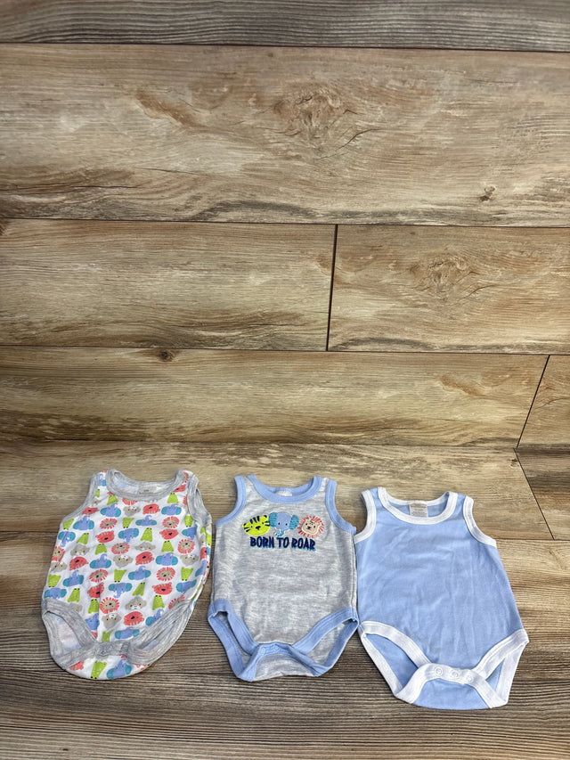 Three sleeveless baby bodysuits on wood floor, featuring animal and solid blue designs