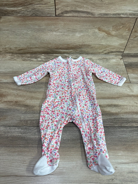 Front view of white floral Mini Hop sleeper showcasing long sleeves, footed legs, and front zipper on a wood floor