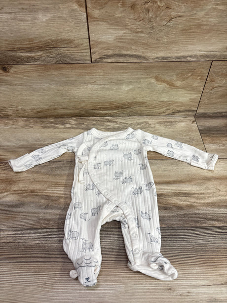 Front view of ivory newborn-size ribbed kimono sleeper showcasing footed legs, long sleeves, and gray sheep print on wood floor