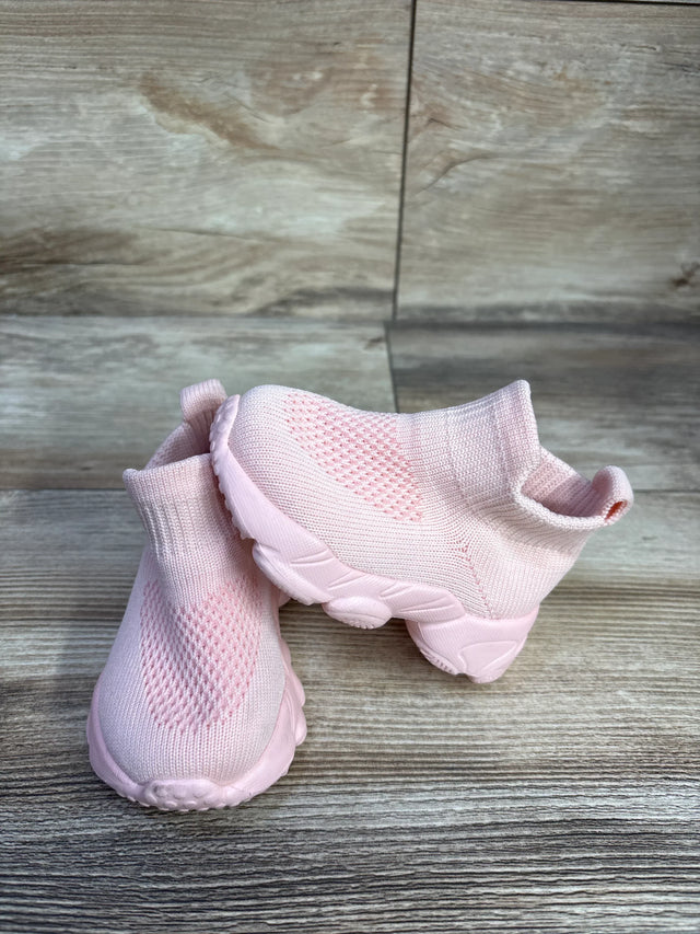 Angled view of pink high-top mesh sock shoes showing knit upper, ankle sock cuff and chunky sole on wood background