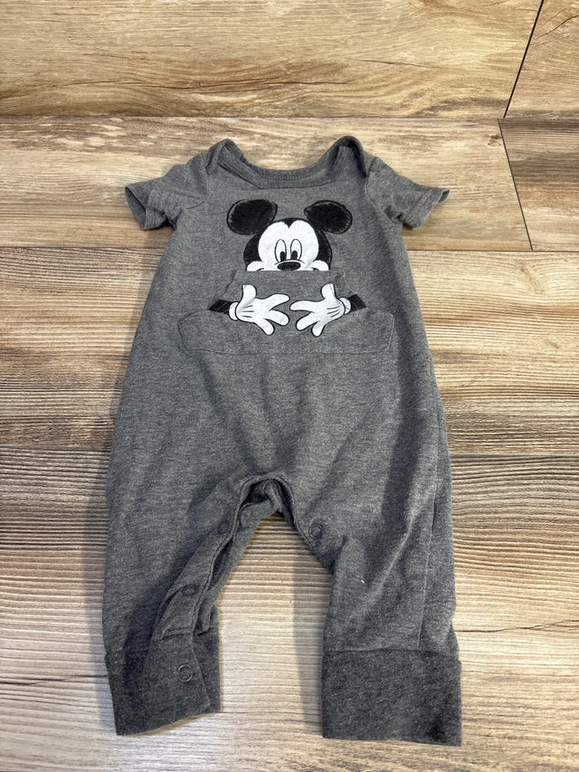 Flat lay of grey Disney Baby Mickey Mouse jumpsuit size 3-6M showing front Mickey print and kangaroo pocket on wood floor background