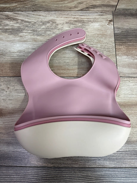 Three PandaEar silicone baby bibs with catch pockets in pink and cream on a wooden surface.