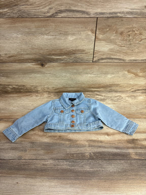 Light blue cropped denim jacket with gold buttons for toddlers displayed on wooden floor