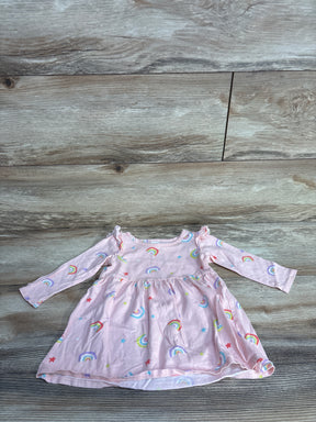 Pink long-sleeve baby dress with rainbow and star prints on wooden floor