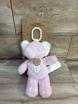 Front view of DreamGro Lullaby travel soother pink elephant showing white stroller hook, heart patch, and soft plush against a wood background