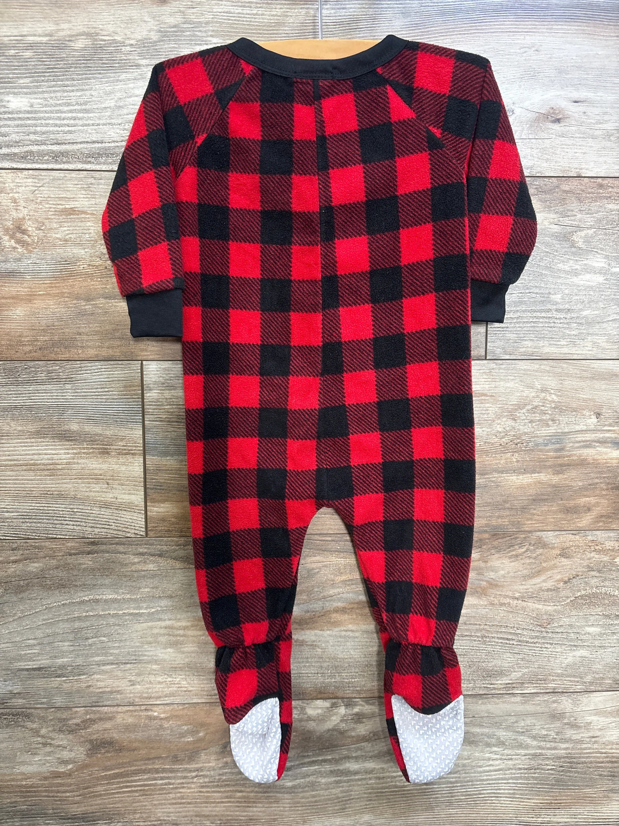 Front view of FollowMe blanket sleeper in red and black buffalo plaid showcasing long sleeves and footed legs with textured non-slip soles on a wood floor background