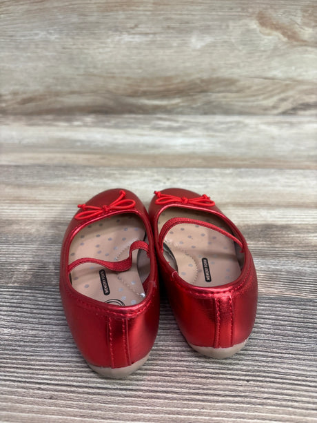 Rear view of red Wonder Nation bow ballet flats showcasing decorative bows and patterned insoles on a wood-grain surface