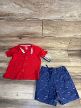 Red OshKosh polo shirt and navy shark-print shorts for kids