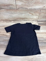 Back view of French Toast black toddler shirt showcasing short sleeves, size 4/5T, flat lay on wood floor