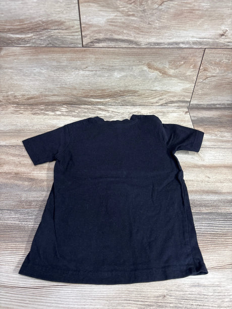 Back view of French Toast black toddler shirt showcasing short sleeves, size 4/5T, flat lay on wood floor