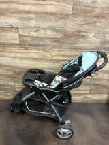 Angled view of Baby Trend EZ Ride Stroller in Doodle Dots showcasing aqua and black seating, front tray, and storage basket