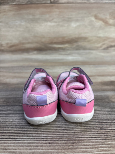 Rear view of See Kai Run Basics Tenny toddler sneakers showcasing pink mesh upper, darker-pink heel panel, white soles, and heel pull tabs on wood background