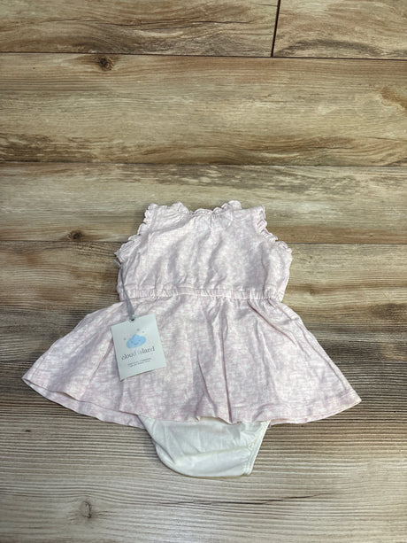 Flat-lay of Cloud Island pink tank dress with attached white bloomers showcasing ruffled sleeves and gathered waist on wood background