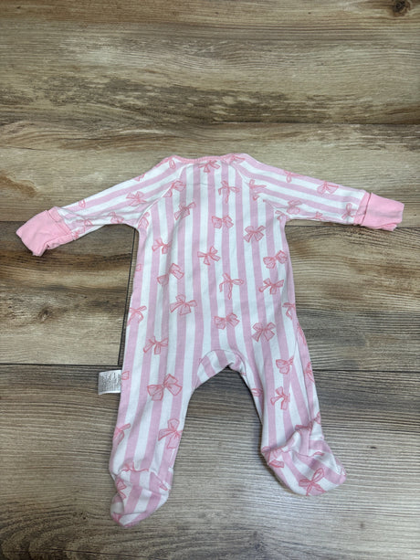 Top-down view of a pink and white striped Yoofoss footed sleeper with bow patterns on a wood surface