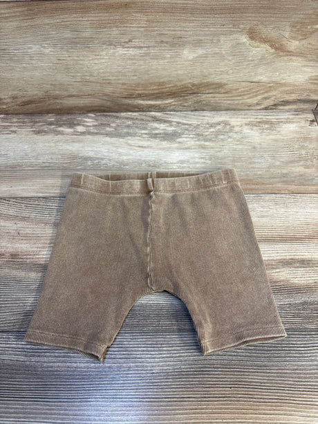 Tan ribbed baby leggings on wood floor, kids clothing resale