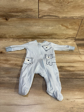 Top view of Carters ribbed sleeper in blue, size 3 months, with bear designs and front zipper on wood flooring