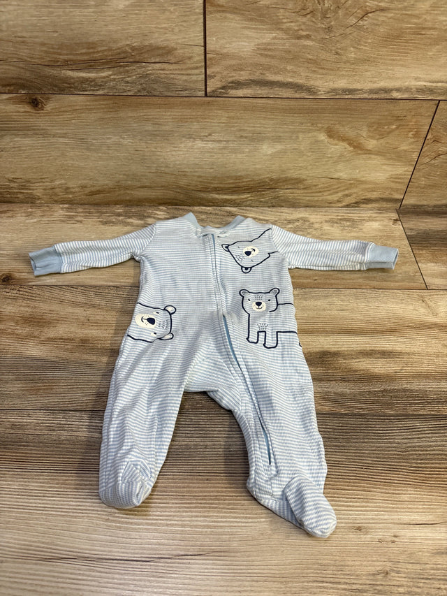 Top view of Carters ribbed sleeper in blue, size 3 months, with bear designs and front zipper on wood flooring