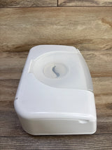 Angled top view of Munchkin Bright & Warm wipe warmer showing closed translucent lid and front tab on wood background