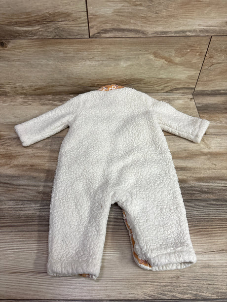 Top view of Nicole Miller white sherpa coverall showcasing long sleeves and full-length legs on a wood-look floor