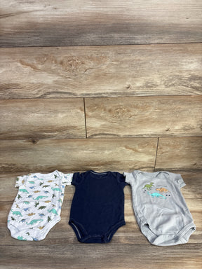 Flat lay of 3-pack Hudson Baby bodysuits size 3-6M showing dinosaur prints and navy bodysuit on wood background
