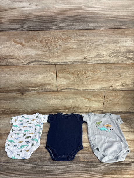 Flat lay of 3-pack Hudson Baby bodysuits size 3-6M showing dinosaur prints and navy bodysuit on wood background