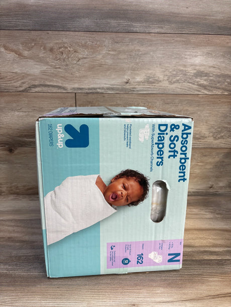Up&Up brand absorbent & soft newborn diapers, 162 count, size N, on wood floor