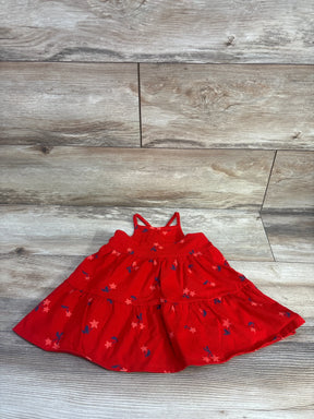 Top-down view of Cat and Jack red toddler tank dress showcasing double spaghetti straps and tiered skirt with pink star and navy leaf print on light wood background