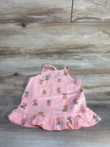 Flat lay of Oshkosh pink pineapple print toddler ruffle tank top 24 months with ruffled hem and thin straps on wood