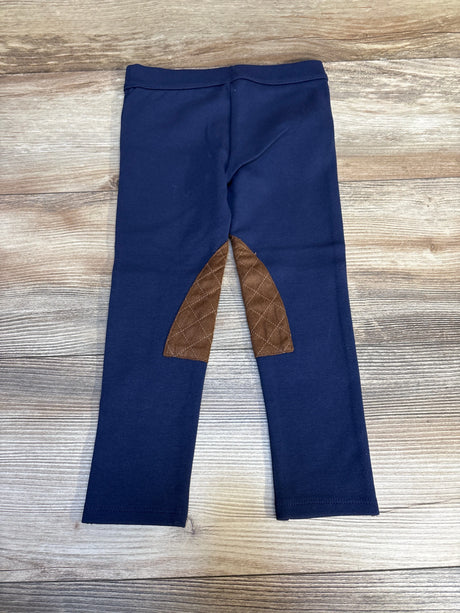 Navy blue kids leggings with brown quilted knee patches on wood background