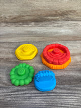 Top view of Baby Einstein 5-piece stacking teethers showing colorful silicone textured pieces on wood background