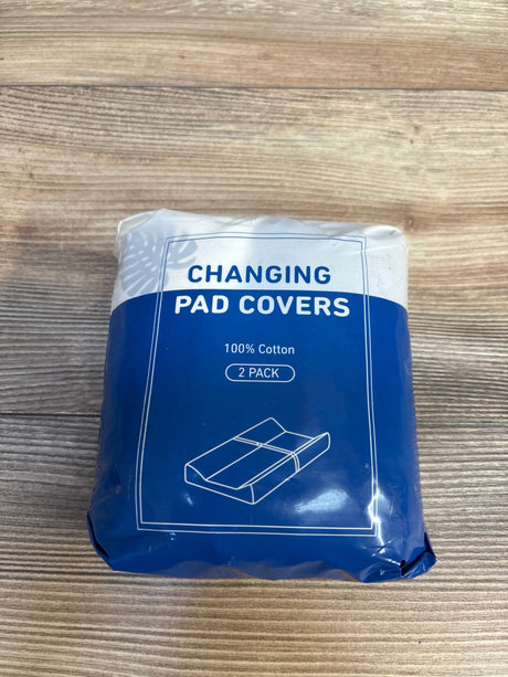 Pack of 2 cotton changing pad covers in blue packaging on wood surface