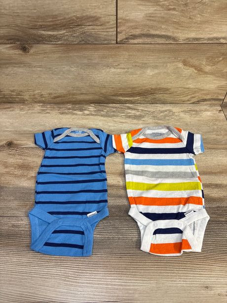 Flat lay of Gerber 2-pack onesies (0-3M) showing a blue striped bodysuit and a multicolor striped bodysuit on wood floor background