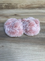 Soft pink faux fur baby booties on wood background, kids footwear resale.