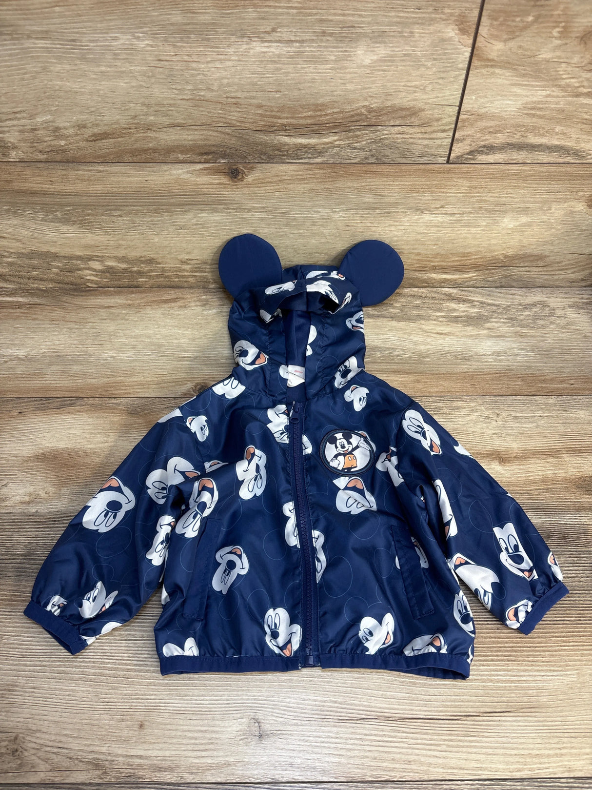 Blue Mickey Mouse kids raincoat with hood ears, perfect for toddler outerwear and playful weather protection.