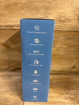 Side of V-Tech TM8112 box showing glow-on-ceiling night light, rechargeable battery and DECT 6.0 features; wooden background