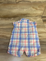 Back view of shortie romper size 6M in pastel plaid showing ruffle cap sleeves and polo collar on wood background