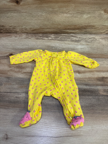 Top view of Simple Joys yellow preemie sleeper showcasing pink dotted pattern, long sleeves, covered feet, and front zipper on wood