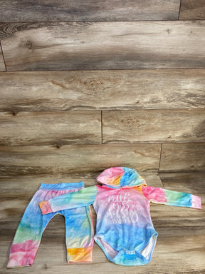 Top-down view of pink tie-dye hooded bodysuit and matching leggings showing the Little Miss Sassy Pants chest print on wood floor