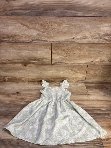 Flat lay of Little Lass smocked girls' dress in pale green with white leaf print, ruffle sleeves, gathered skirt, 4T