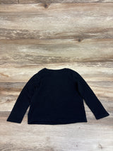 Front view of Old Navy black thermal shirt in size 3T showcasing long sleeves and ribbed knit texture with a wood background