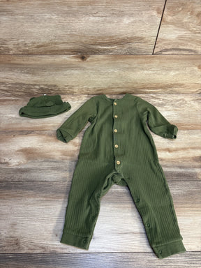 Olive green ribbed baby romper with matching hat, wooden buttons, laid on wood floor