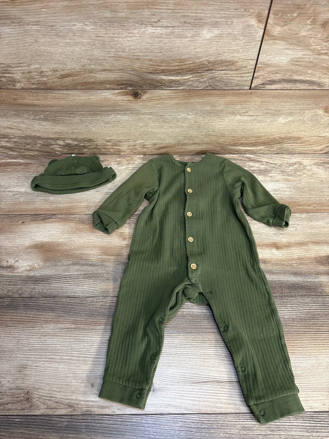 Olive green ribbed baby romper with matching hat, wooden buttons, laid on wood floor