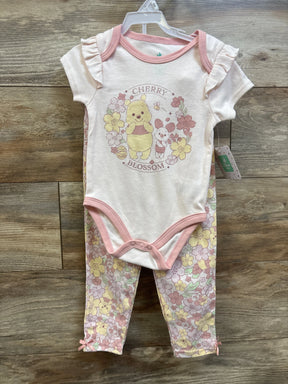 Front view of pink Disney Baby Winnie the Pooh bodysuit set with ruffled sleeves, floral pants, and Cherry Blossom graphic