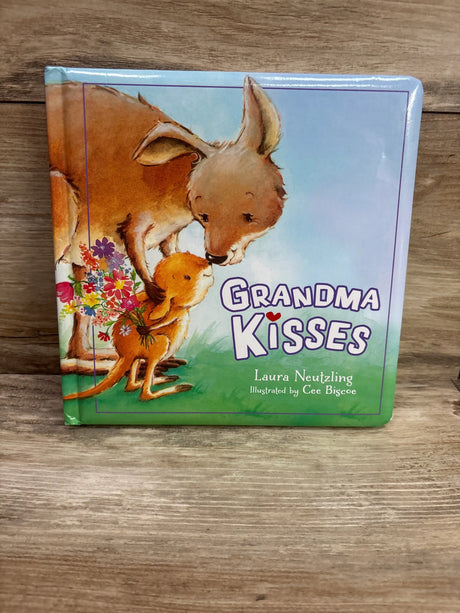Front view of Grandma Kisses board book showcasing a kangaroo and joey with flowers on a wooden background
